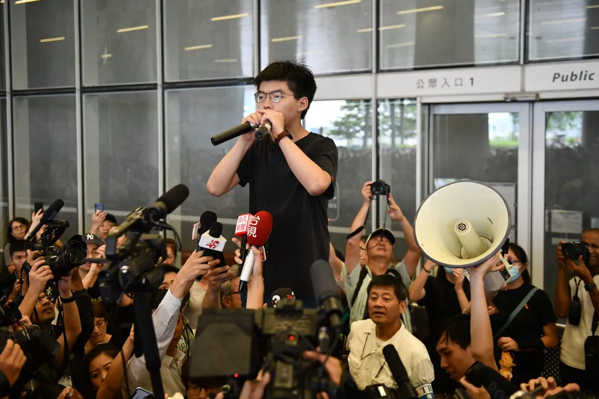 Pro-democracy activist Joshua Wong speaks to the media and supporters outside the Legislative Council shortly after being released from prison in Hong Kong on June 17, 2019. (Carl Court/Getty Images)