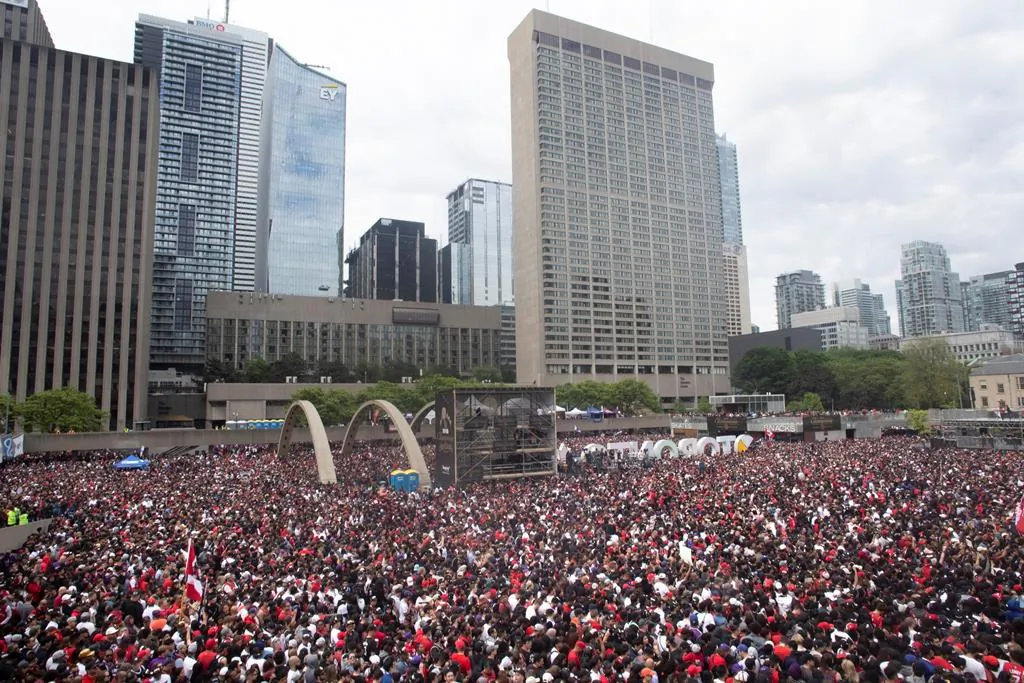 Crowds gather in Nathan Phillips Square as they prepare to celebrate the Toronto Raptors winning the NBA Championship in Toronto on June 17, 2019. (Chris Young/The Canadian Press)