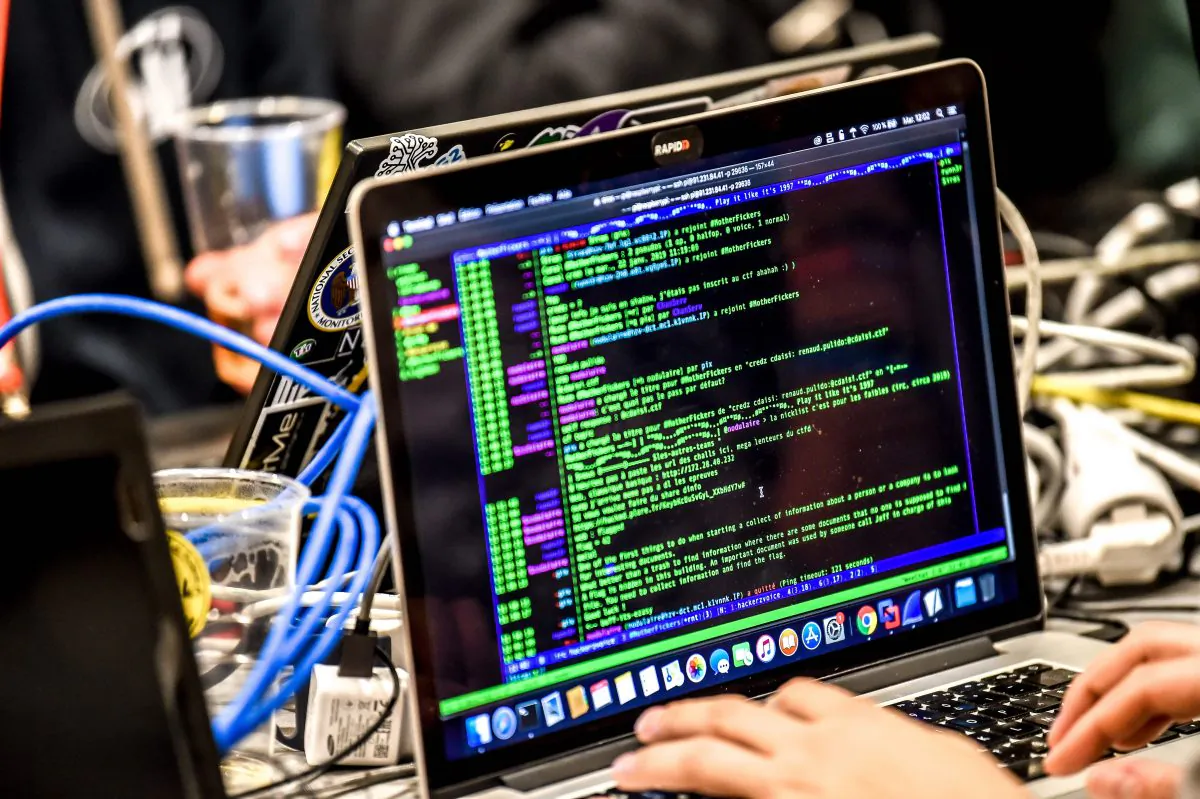 A person delivers a computer payload while working on a laptop in Lille, France, during the 11th International Cybersecurity Forum on Jan. 22, 2019. (PHILIPPE HUGUEN/AFP/Getty Images)