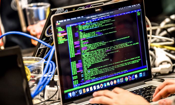 A person delivers a computer payload while working on a laptop during the 11th International Cybersecurity Forum in Lille, France, on Jan. 22, 2019. (Philippe Huguen/AFP/Getty Images)