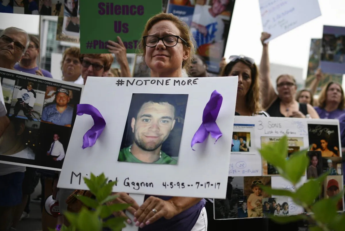 Christine Gagnon of Southington, Conn. protests with other family and friends who have lost loved ones to OxyContin and opioid overdoses at Purdue Pharma LLP headquarters in Stamford, Conn., on Aug. 17, 2018.  (Jessica Hill/AP Photo)