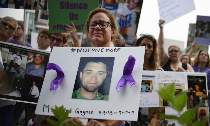Christine Gagnon of Southington, Conn. protests with other family and friends who have lost loved ones to OxyContin and opioid overdoses at Purdue Pharma LLP headquarters in Stamford, Conn., on Aug. 17, 2018.  IAP Photo/Jessica Hill)
