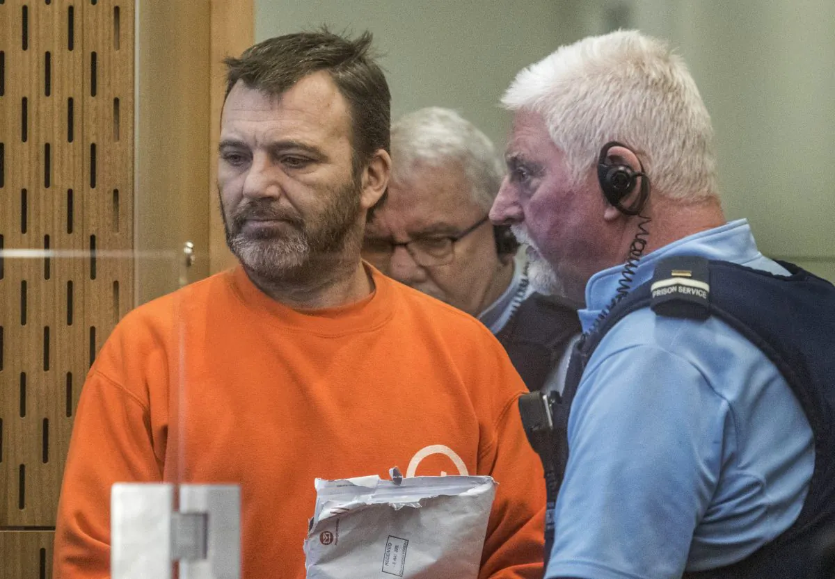 Philip Neville Arps, left, appears for sentencing in the Christchurch District Court, in Christchurch, New Zealand, Tuesday, June 18, 2019.  The Christchurch businessman who shared a video of worshippers being slaughtered at a New Zealand mosque has been sentenced to 21 months in prison. (John Kirk-Anderson/Pool/AP)
