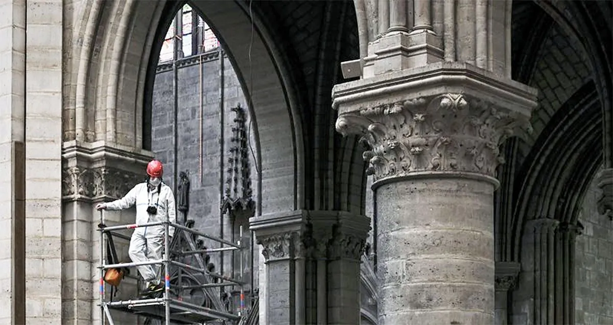 A worker stands on scaffolding during preliminary work inside the Notre Dame de Paris Cathedral in Paris on May 15, 2019. (Philippe Lopez/Pool via AP, File)