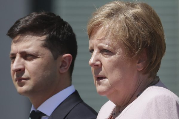 German Chancellor Angela Merkel welcomes Ukraine's President Volodymyr Zelenskiy with military honors for a meeting at the chancellery in Berlin,