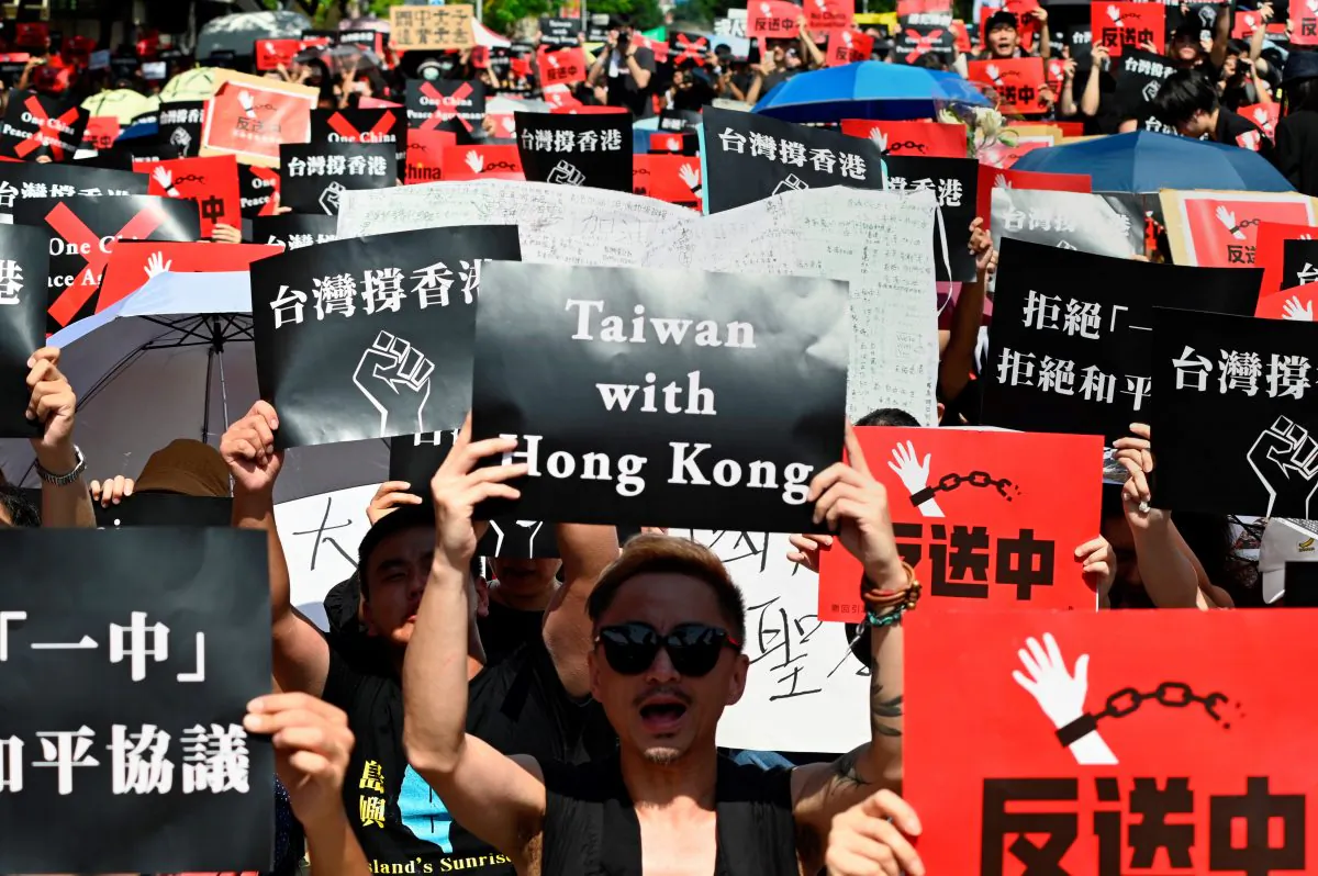 Protesters display placards during a demonstration in support of the continuing protests taking place in Hong Kong against a controversial extradition law proposal in Taipei, on June 16, 2019. (Sam Yeh/AFP/Getty Images)