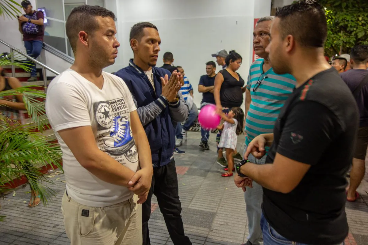 SOME DESERTERS DISCUSS THEIR NEXT STEPS OUTSIDE THE HOTEL THEY ARE CURRENTLY HOLED UP IN CÚCUTA ,COLOMBIA, on MAY 3 .