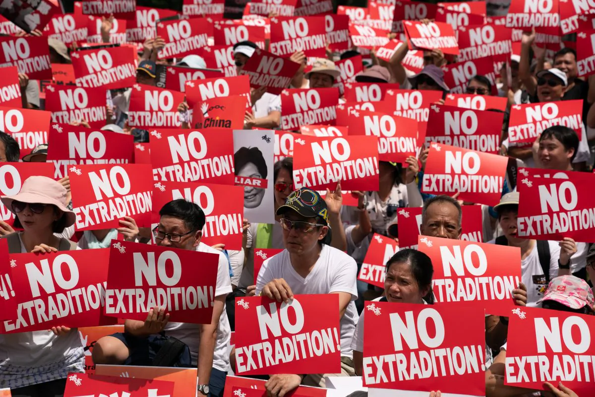 Protesters hold placards and shout slogans during a rally against the extradition law proposal in Hong Kong on June 9, 2019. (Anthony Kwan/Getty Images)