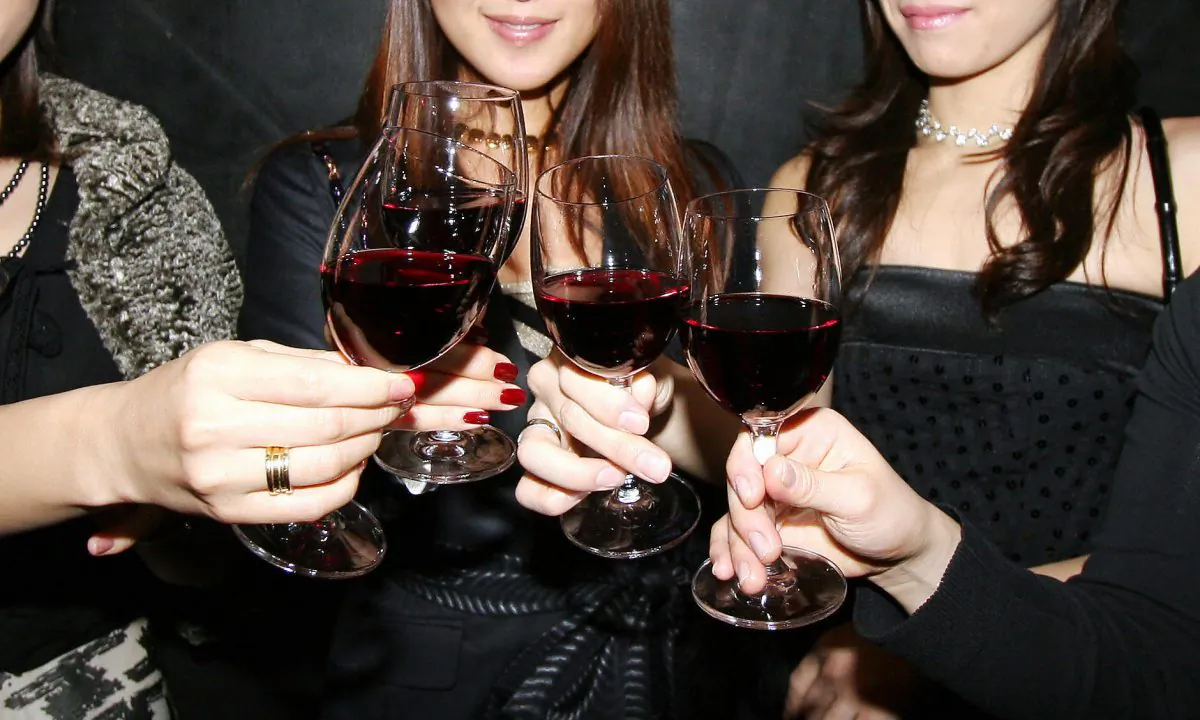Women pose with their glasses for a toast. (Yoshikazu Tsuno/AFP/Getty Images)