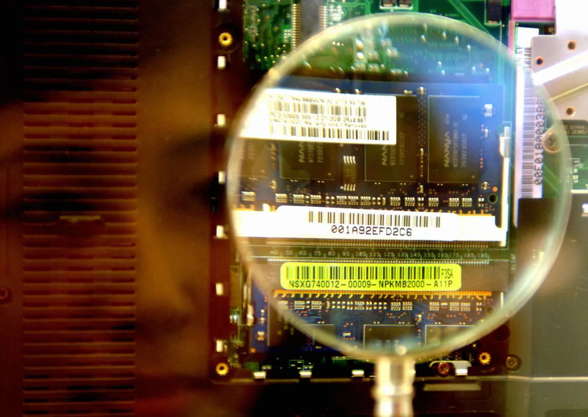 A woman looks through a magnifier to see a 2GB RAM from a notebook during the semi-tech show in Taipei 10 in May 2007.  (Sam Yeh/AFP/Getty Images)