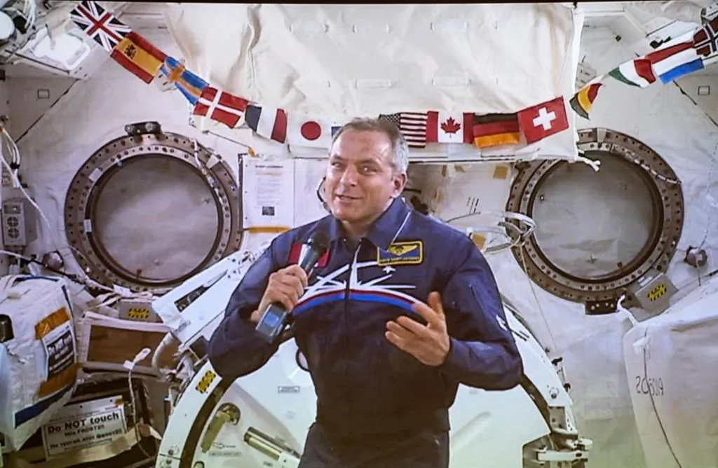 Canadian Space Agency astronaut David Saint-Jacques responds to a question during his last press conference in orbit before returning to Earth on June 24, seen on a giant screen in Saint-Hubert, QB. on June 19, 2019. (Paul Chiasson/The Canadian Press)