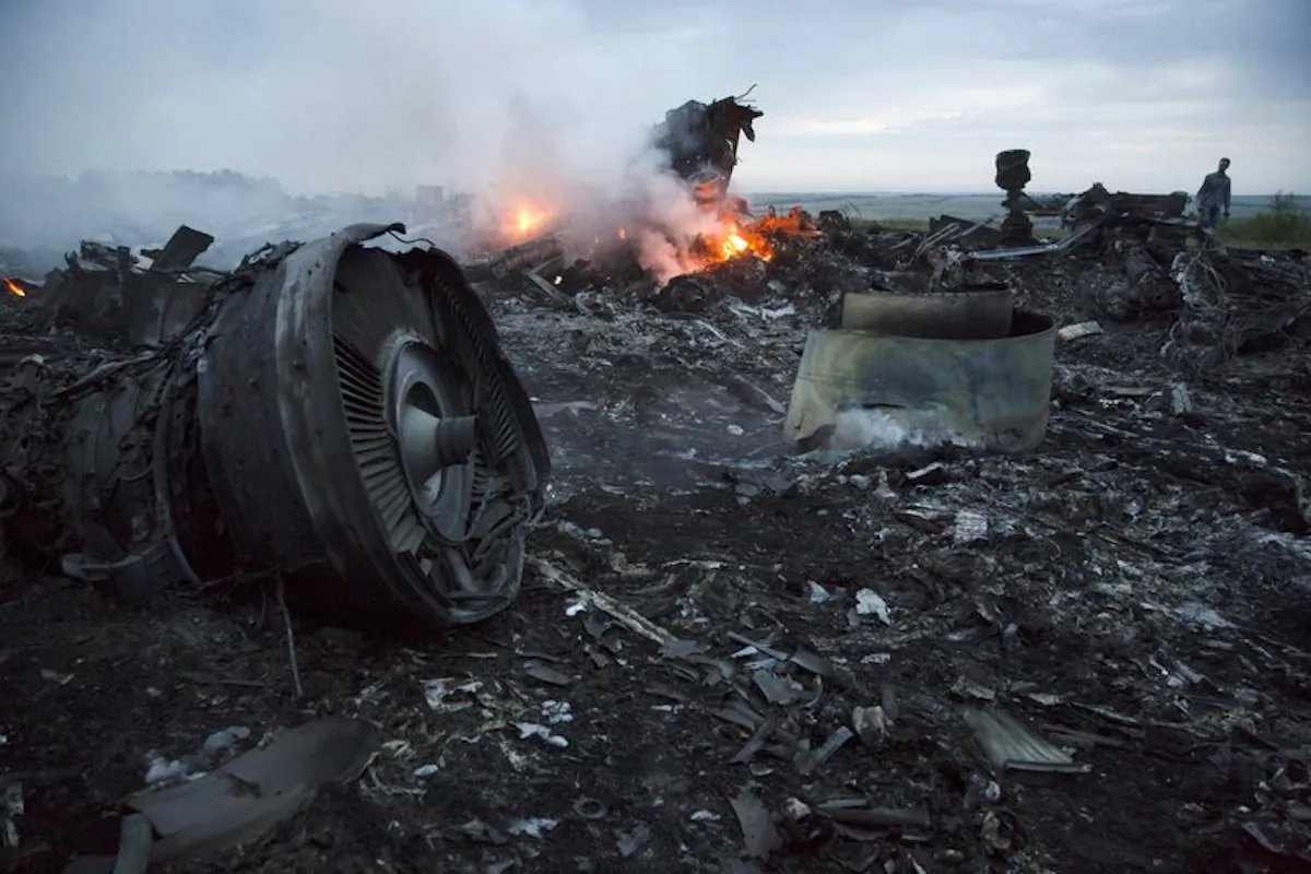 A man walks amongst the debris at the crash site of a passenger plane near the village of Hrabove, Ukraine, on July 17, 2014. (Dmitry Lovetsky/AP Photo)
