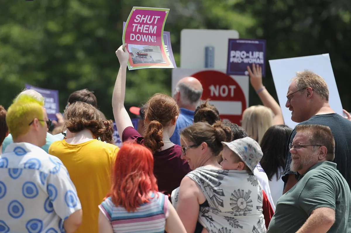 A group of demonstrators display signs during a pro-life rally outside the Planned Parenthood Reproductive Health Center in St Louis, Missouri, on June 4, 2019. (Michael B. Thomas/Getty Images)