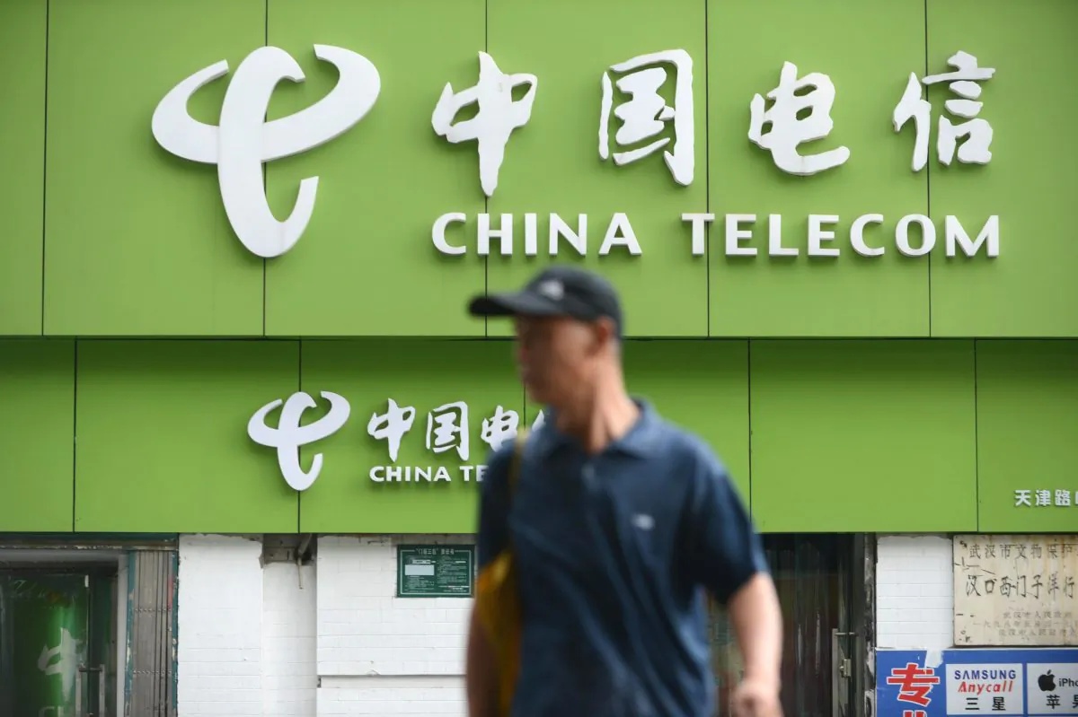 A man walks past a China Telecom store in Wuhan, in central China's Hubei Province on Aug. 21, 2013. (STR/AFP/Getty Images)