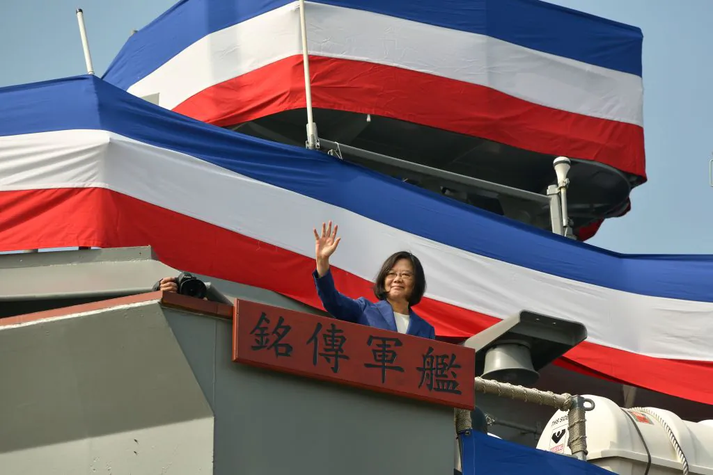 Taiwan's President Tsai Ing-Wen waves to assembled guests from the deck of the 'Ming Chuan' frigate during a ceremony to commission two Perry-class guided missile frigates from the United States into the Taiwan Navy, in the southern port of Kaohsiung on Nov. 8, 2018. (Chris Stowers/AFP/Getty Images)