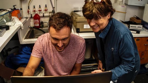 Dr. Nathan Robinson and Dr. Edie Widder view giant squid footage