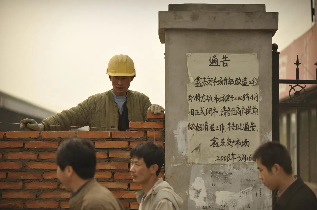 A notice is posted telling vendors to pack up their shops, at a once-bustling food market which has closed down and is being demolished, in Beijing on March 31, 2008. (Peter Parks/AFP/Getty Images)