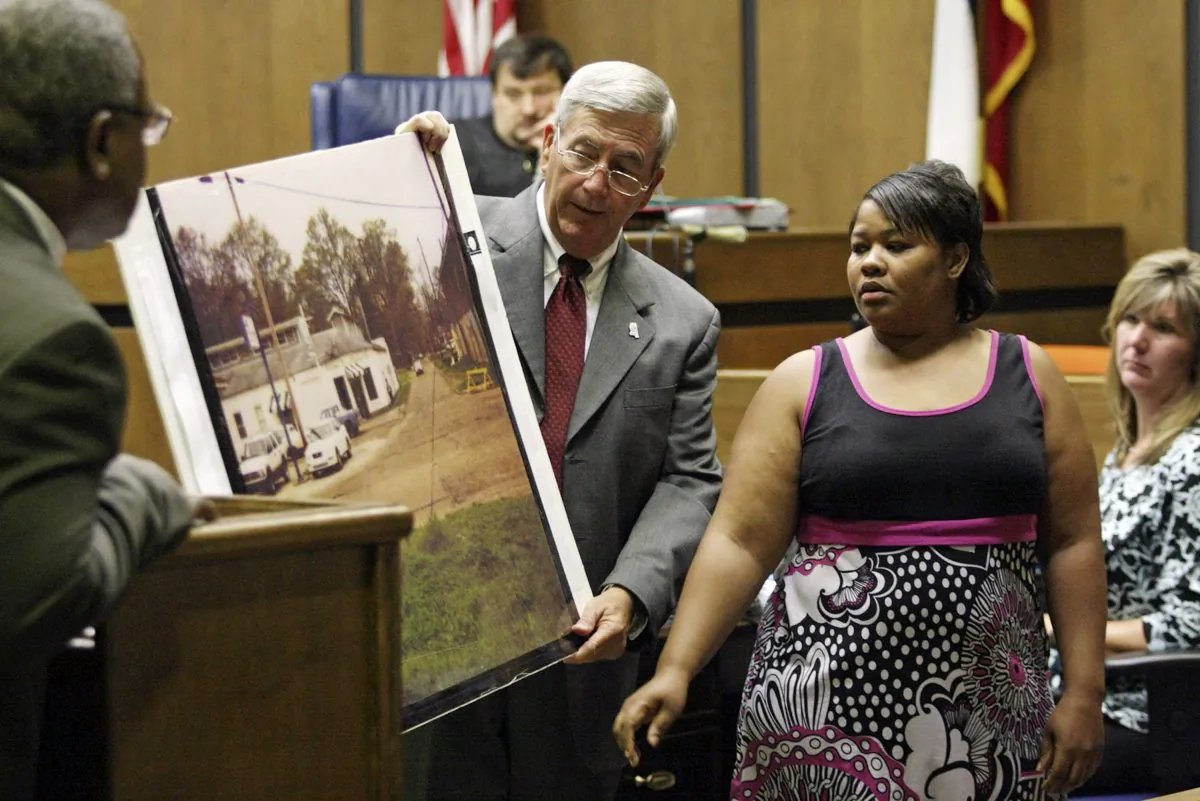 Clemmie Flemming points out to prosecutor Doug Evans, center, where she spotted Curtis Giovanni Flowers on the morning of four slayings at Tardy Furniture in Greenwood, Miss., on June 14, 2010. (Taylor Kuykendall/The Commonwealth via AP, File)