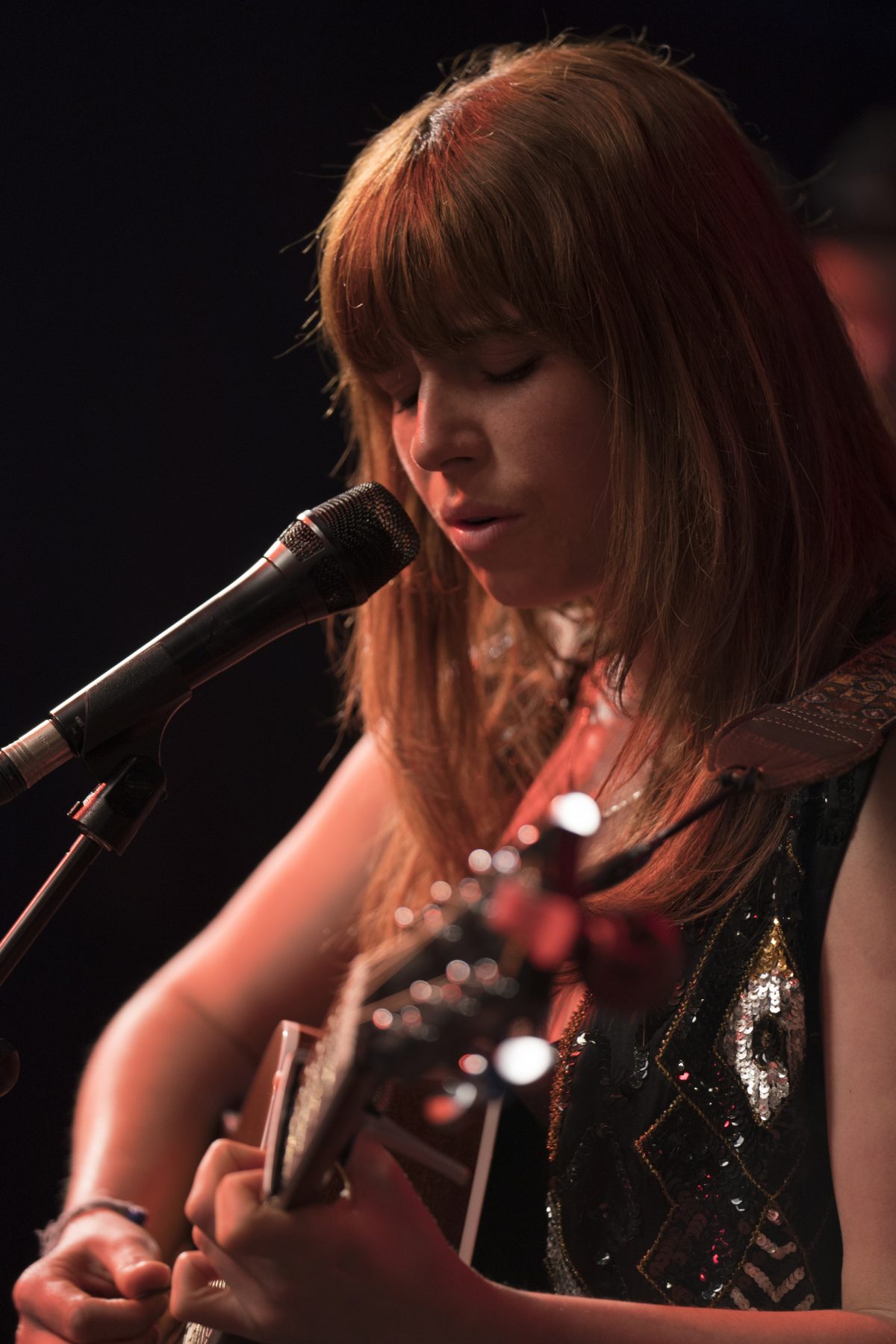 ginger singer playing guitar