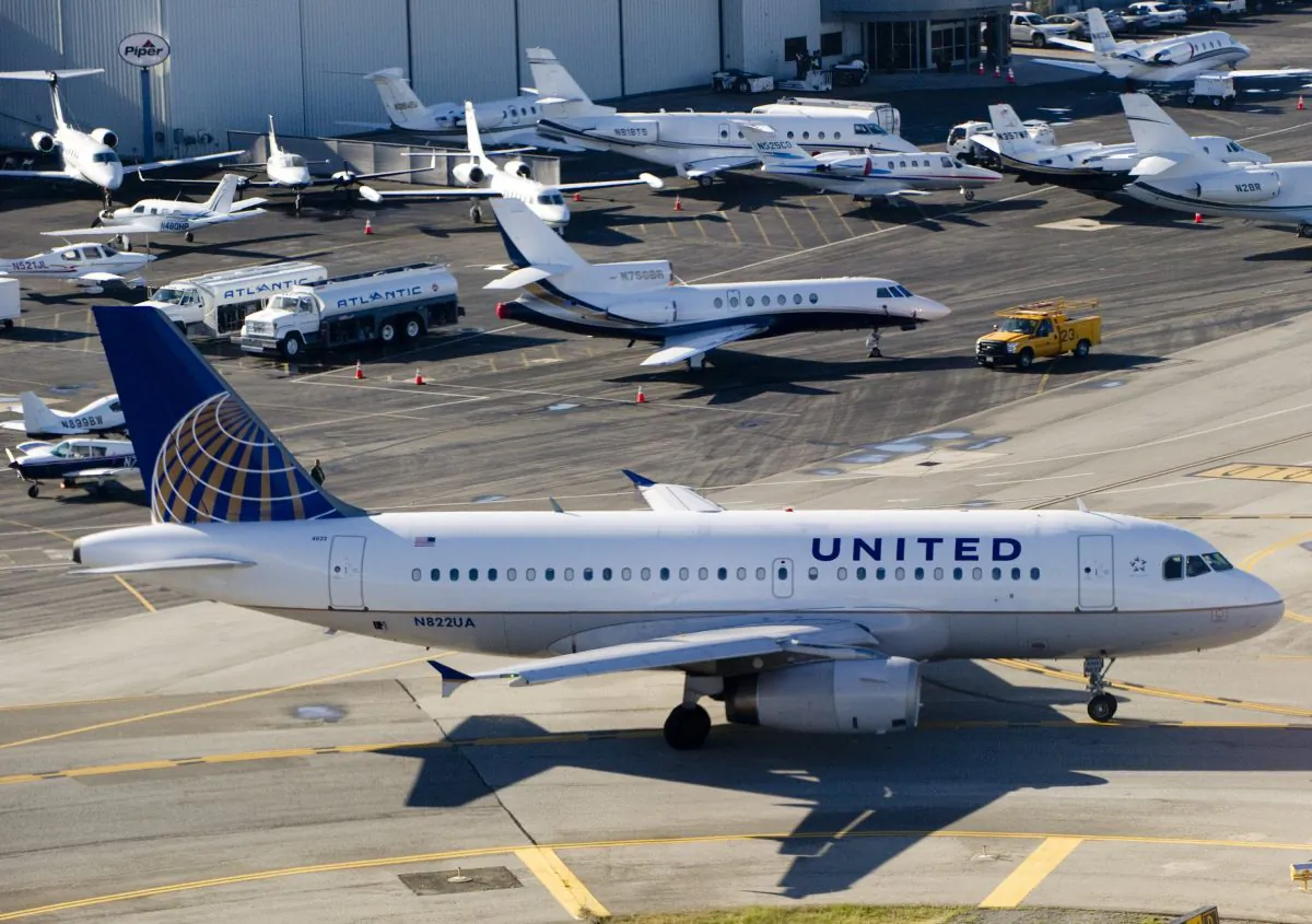 A United Airlines Airbus A319 airplane waits to take off alongside private jets at John Wayne Airport in Santa Ana, Calif., on Feb. 16, 2012. (Saul Loeb/AFP/Getty Images)