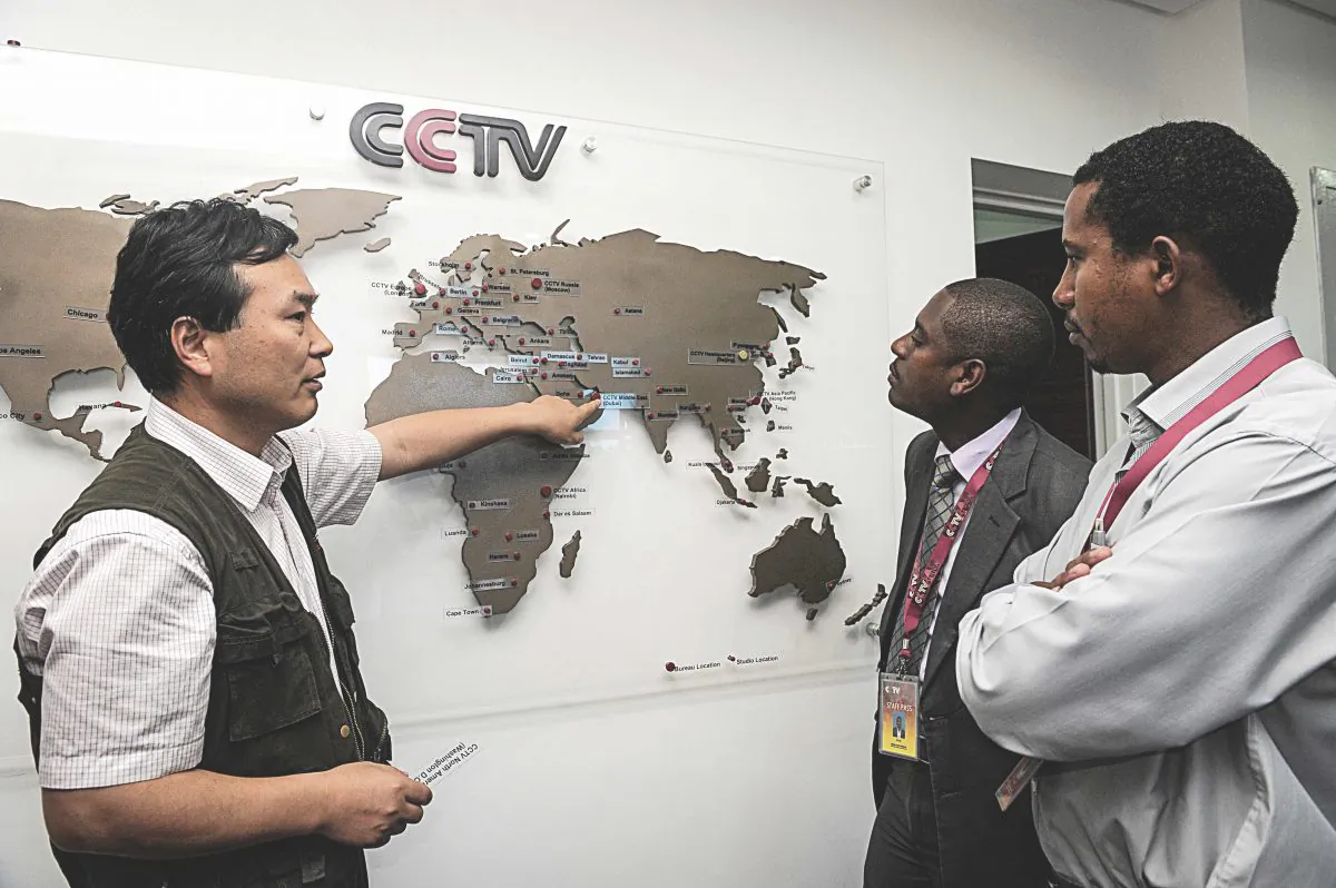 Pang Xinhua (L), managing editor of China Central Television Africa, talks to local journalists in Nairobi, Kenya, as he shows them how the organization has expanded in different parts of Africa, on June 12, 2012. (SIMON MAINA/AFP/GettyImages)