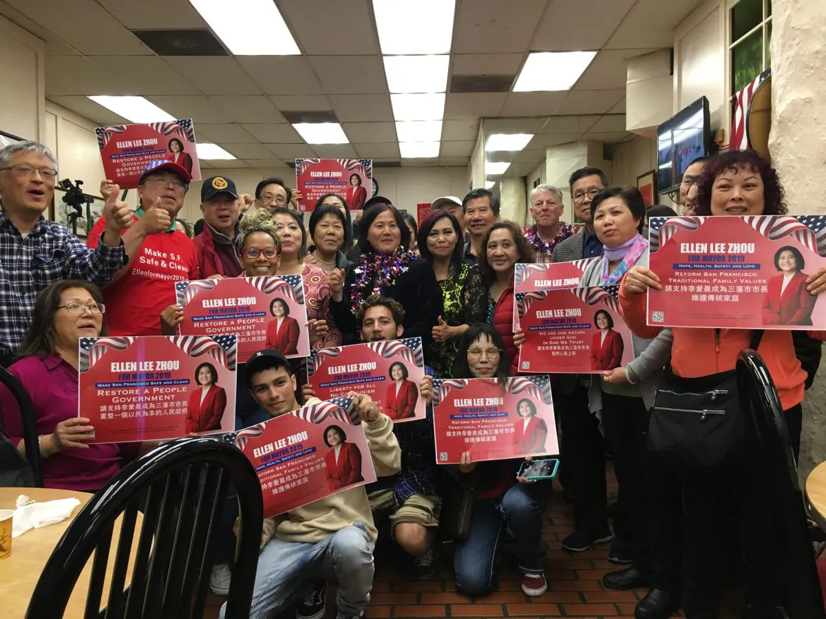 San Franciscan's hold posters to show support for Ellen Zhou during dinner gathering on June 18, 2019. (Illene Eng/NTD)