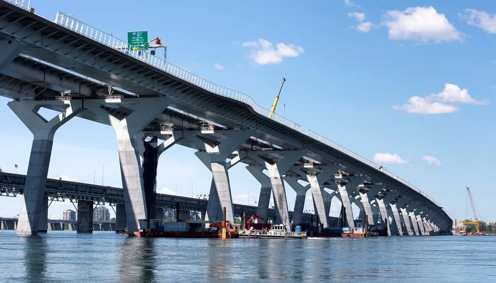 The new Samuel de Champlain bridge is seen with the old bridge in the background in Montreal on June 17, 2019. (Paul Chiasson/The Canadian Press)