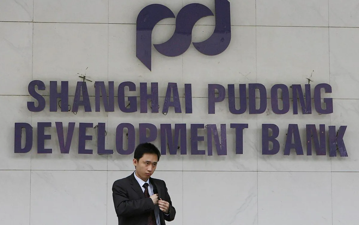 A customer leaves a branch of the Shanghai Pudong Development Bank in Shanghai, 08 June 2006. (Mark Ralston/AFP/Getty Images)