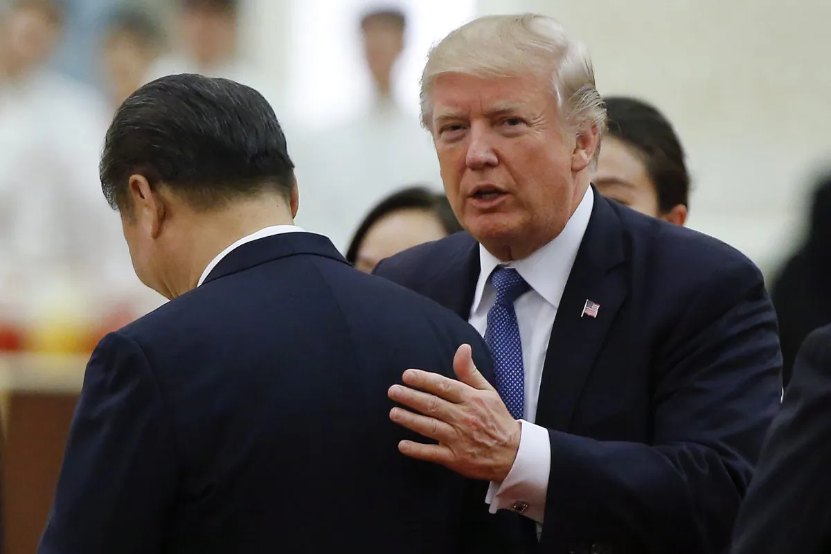US President Donald Trump (R) speaks to Chinese Leader Xi Jinping during a state dinner in the Great Hall of the People in Beijing on Nov. 9, 2017. (THOMAS PETER/AFP/Getty Images)