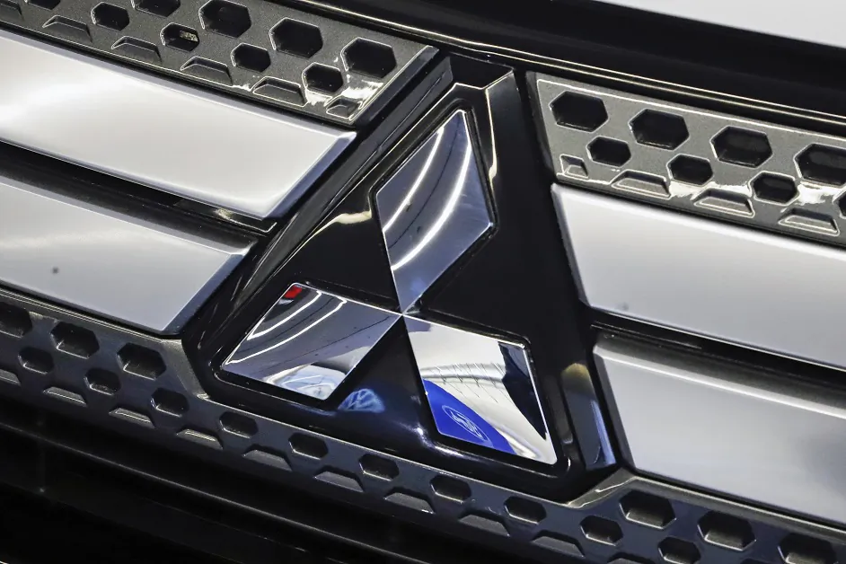 The Mitsubishi logo on the front grill of a 2019 Mitsubishi Outlander GT on display at the 2019 Pittsburgh International Auto Show in Pittsburgh on Feb. 14, 2019. (AP Photo/Gene J. Puskar, File)