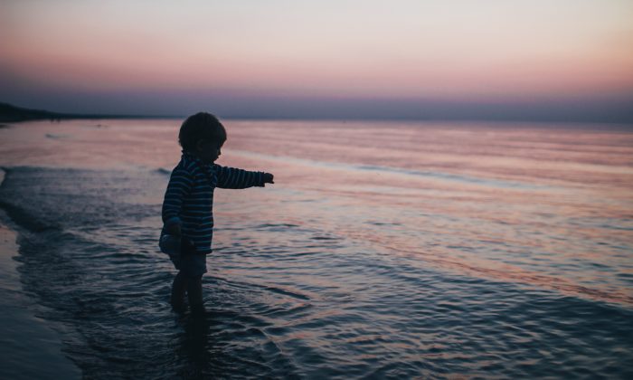 A Child playing at the seashore.