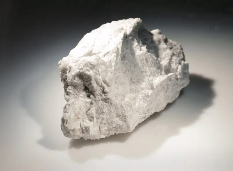 The "Genesis Rock," a 4.4 billion-year-old anorthosite sample approximately 2 inches in length, brought back by Apollo 15 and used to determine the moon was formed by a giant impact, is lit inside a pressurized nitrogen-filled examination case in the lunar lab at the NASA Johnson Space Center in Houston on June 17, 2019. (Michael Wyke/AP)