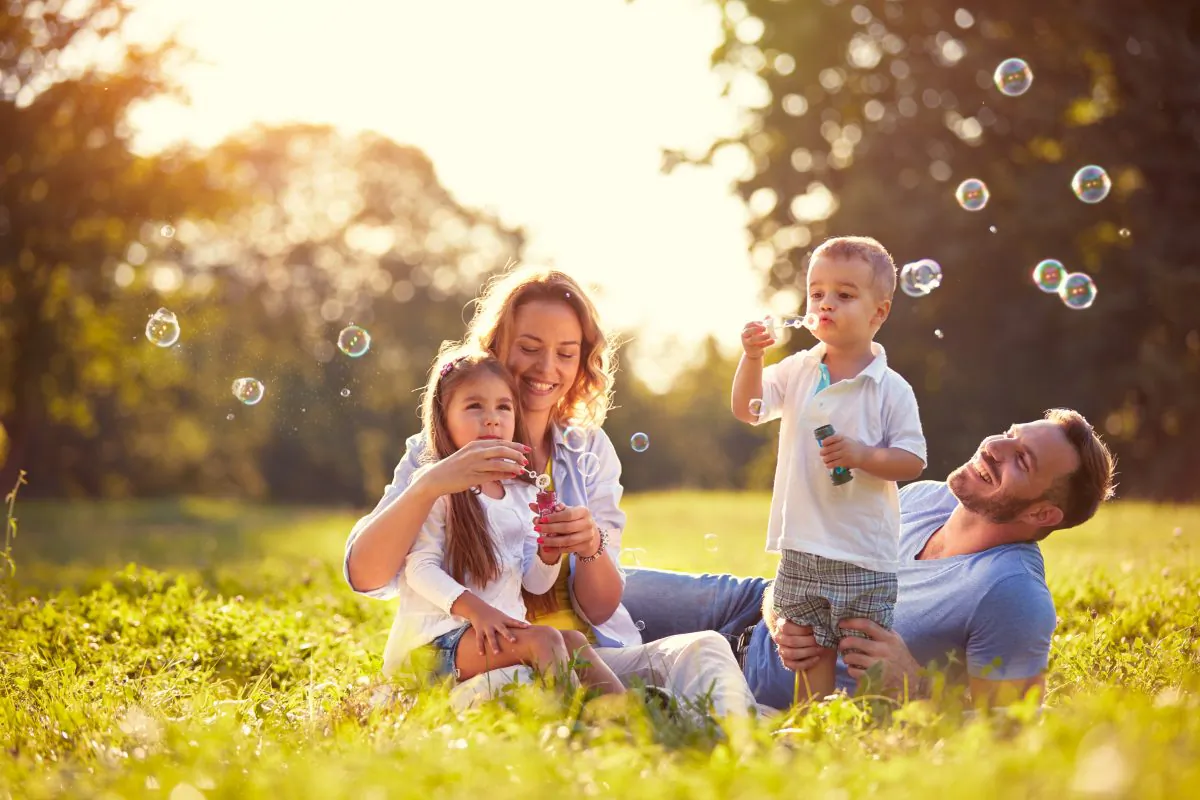 Undated image of a family playing in a park. (Lucky Business/Shutterstock)