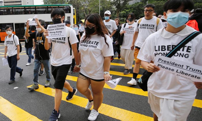 Hong Kong activists march to major international consulates in an attempt to rally foreign governments' support for their fight against a controversial extradition bill, in Hong Kong, China on June 26, 2019. (Ann Wang/Reuters)