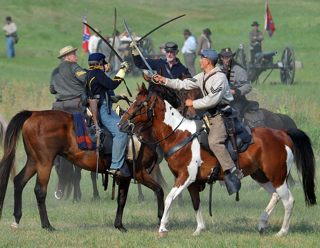 Union cavalry troops engage Confederate cavalry with sabers during the Battle at the Sherfy House on July 2, 2011 during re-enactments of battles at the Gettysburg National Military Park in Pennsylvania. (KAREN BLEIER/AFP/Getty Images)