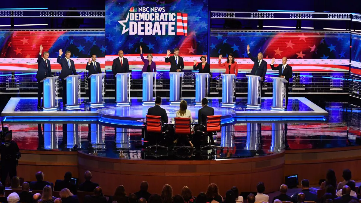 Democratic presidential candidates (from L) New York City Mayor Bill de Blasio, Rep. Tim Ryan (Ohio), former U.S. Secretary of Housing and Urban Development Julian Castro, Sen. Cory Booker (N.J.), Sen. Elizabeth Warren (Mass.), former Texas Rep. Beto O'Rourke, Sen. Amy Klobuchar (Minn.), Rep. Tulsi Gabbard (Hawaii), Washington Gov. Jay Inslee, and former Maryland Rep. John Delaney participate in the first Democratic primary debate of the 2020 presidential campaign season hosted by NBC News at the Adrienne Arsht Center for the Performing Arts in Miami, Florida, June 26, 2019. (Jim Watson/AFP/Getty Images)