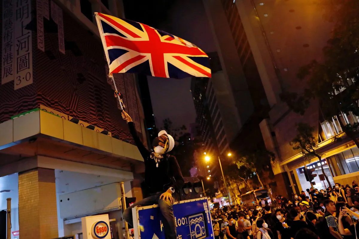 A demonstrator waves Union Flag during a demonstration outside police headquarters, demanding Hong Kong's leaders to step down and withdraw the extradition bill, in Hong Kong, China on June 27, 2019. (Tyrone Siu/Reuters)