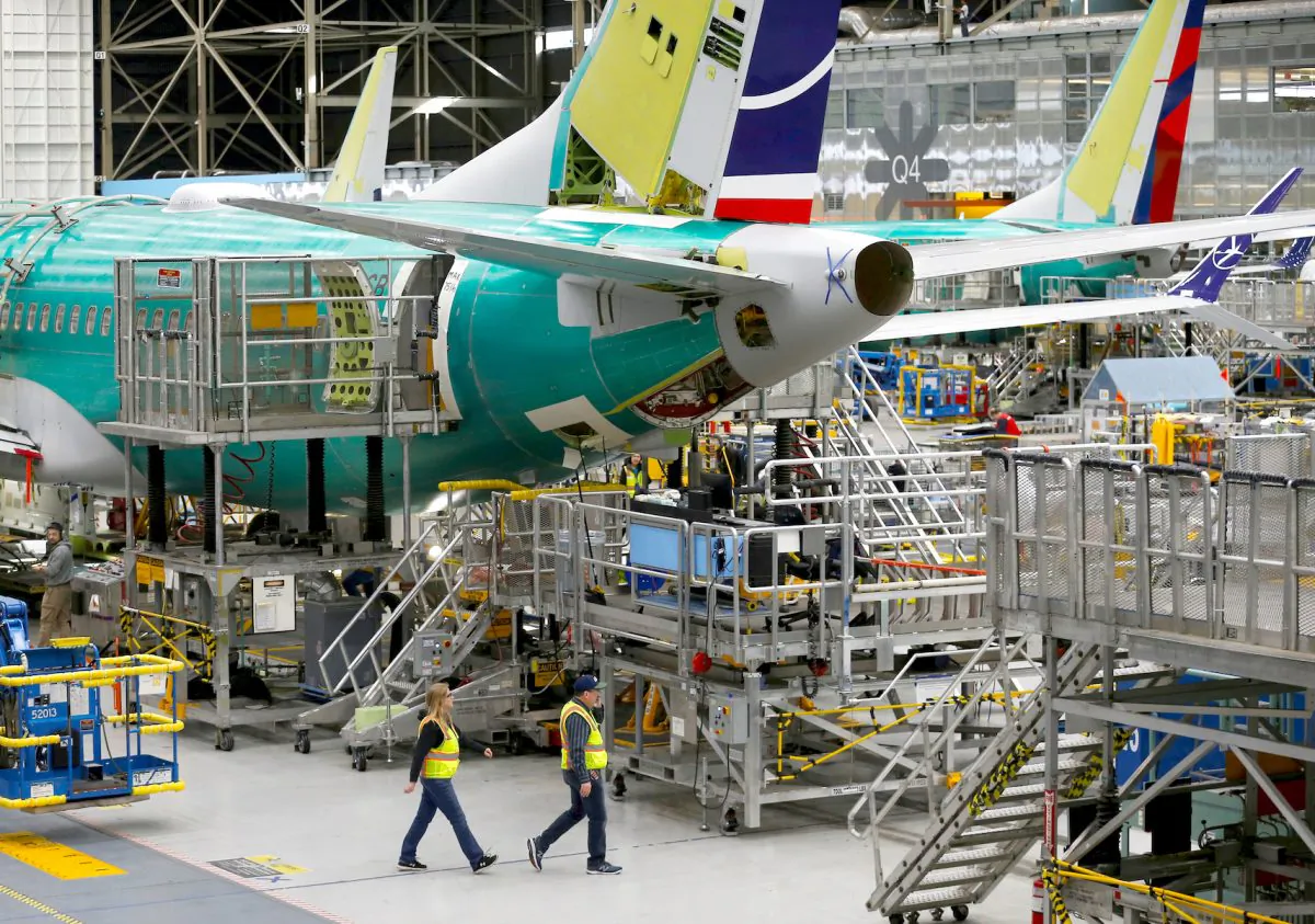Employees walk by the end of a 737 Max aircraft at the Boeing factory in Renton, Washington, U.S., on March 27, 2019.  (Reuters/Lindsey Wasson/File Photo)