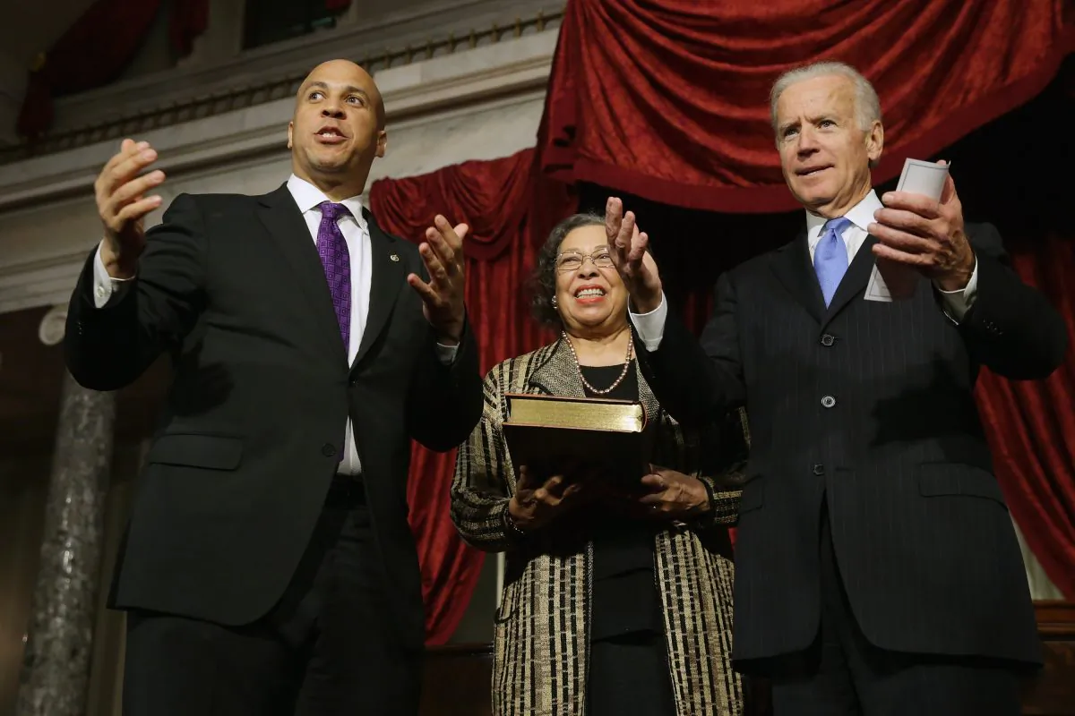 Sen. Cory Booker (D-NJ) (L) and U.S. Vice President Joe Biden beckon to Booker's family after a ceremonial swearing-in with his mother Carolyn Booker in the Old Senate Chamber at the U.S. Capitol Oct. 31, 2013 in Washington, DC. (Chip Somodevilla/Getty Images)