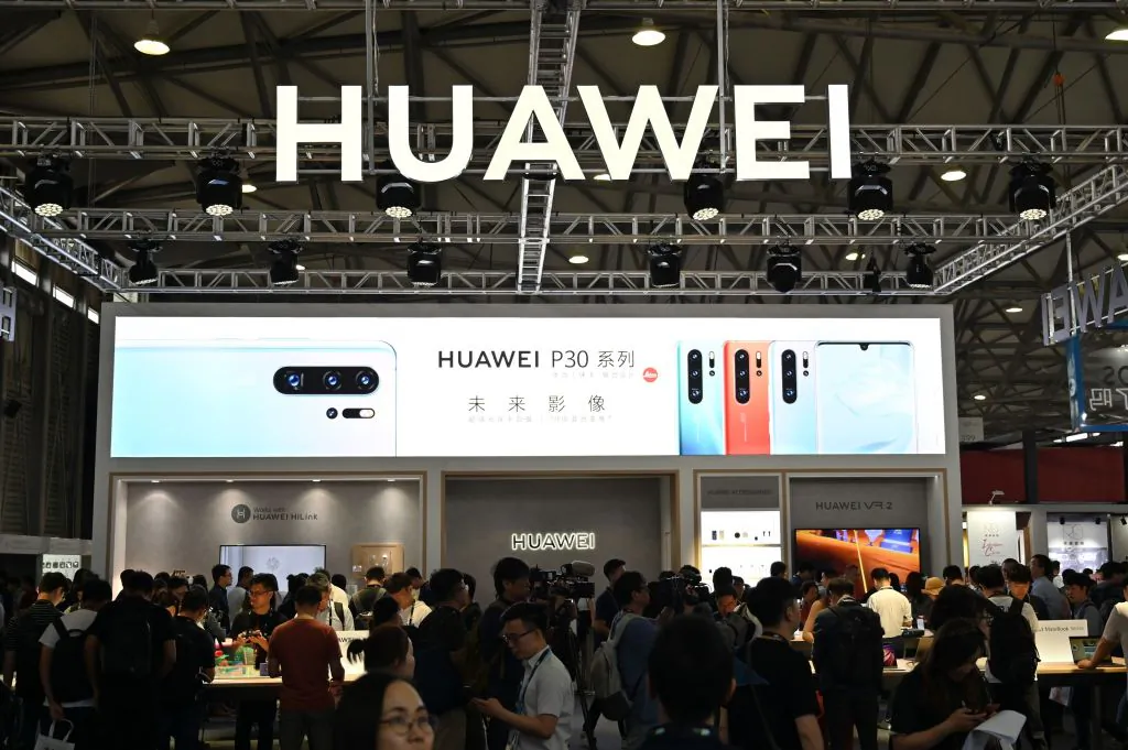 People gather at a Huawei stand during the Consumer Electronics Show, CES Asia 2019 in Shanghai on June 11, 2019. (Hector Retamal/AFP/Getty Images)