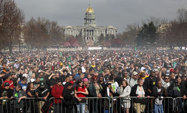 Marijuana smoke rises from a smoking crowd