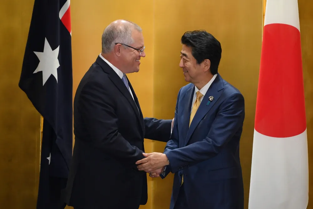 Australian Prime Minister Scott Morrison and Prime Minister of Japan Shinzo Abe shake hands during a bilateral meeting ahead of the official start of the G20 summit in Osaka, Japan, on June 27, 2019. (AAP Image/Lukas Coch)