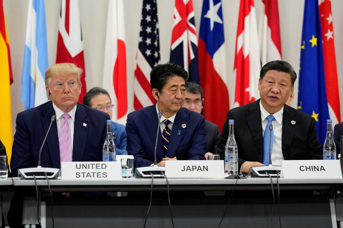 Japan's Prime Minister Shinzo Abe is flanked by U.S. President Donald Trump and Chinese leader Xi Jinping during a meeting at the G20 leaders summit in Osaka, Japan on June 28, 2019. (Kevin Lamarque/Reuters)