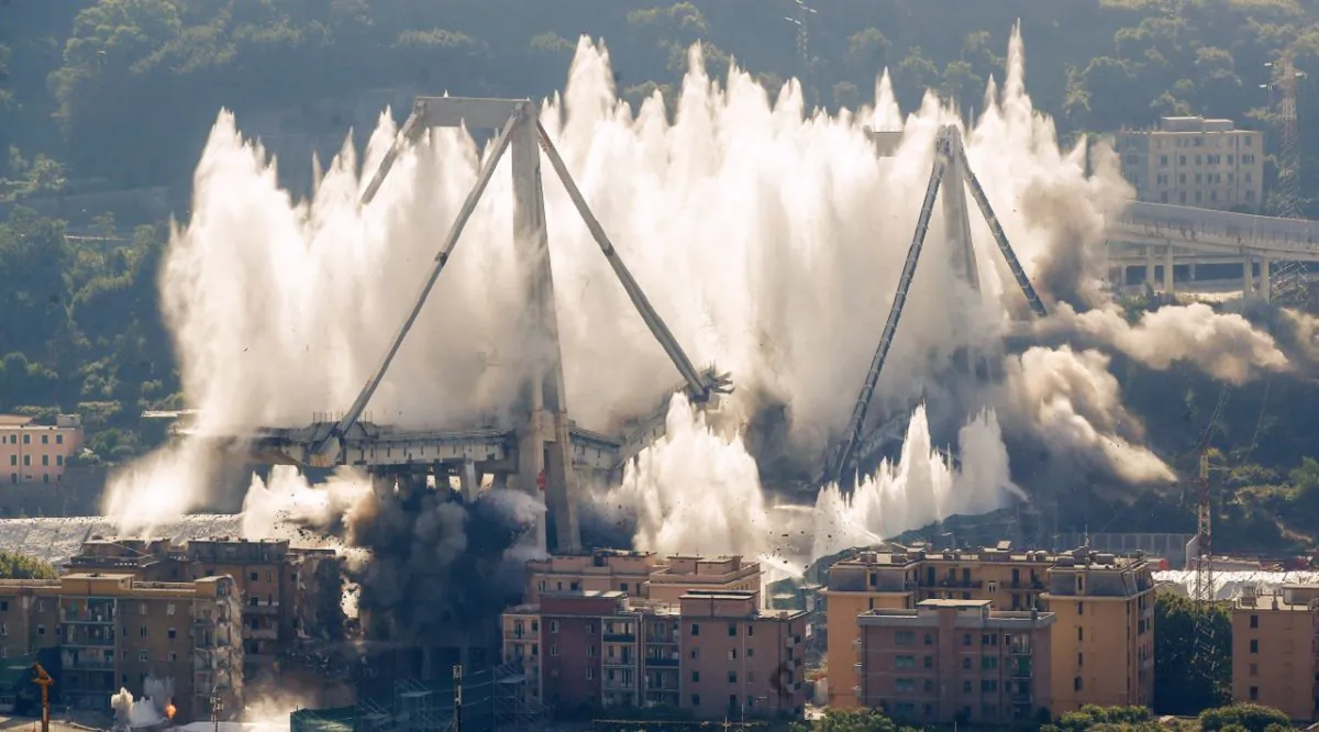 A cloud of dust rises as the remaining spans of the Morandi bridge are demolished in a planned explosion, in Genoa, Italy, on June 28, 2019. (Antonio Calanni/AP Photo)