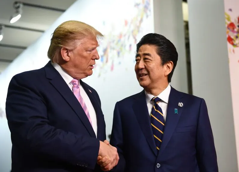 Japanese Prime Minister Shinzo Abe welcomes U.S. President Donald Trump at the G-20 Osaka Summit in Osaka on June 28, 2019. (Brendon Smialowski/AFP/Getty Images)