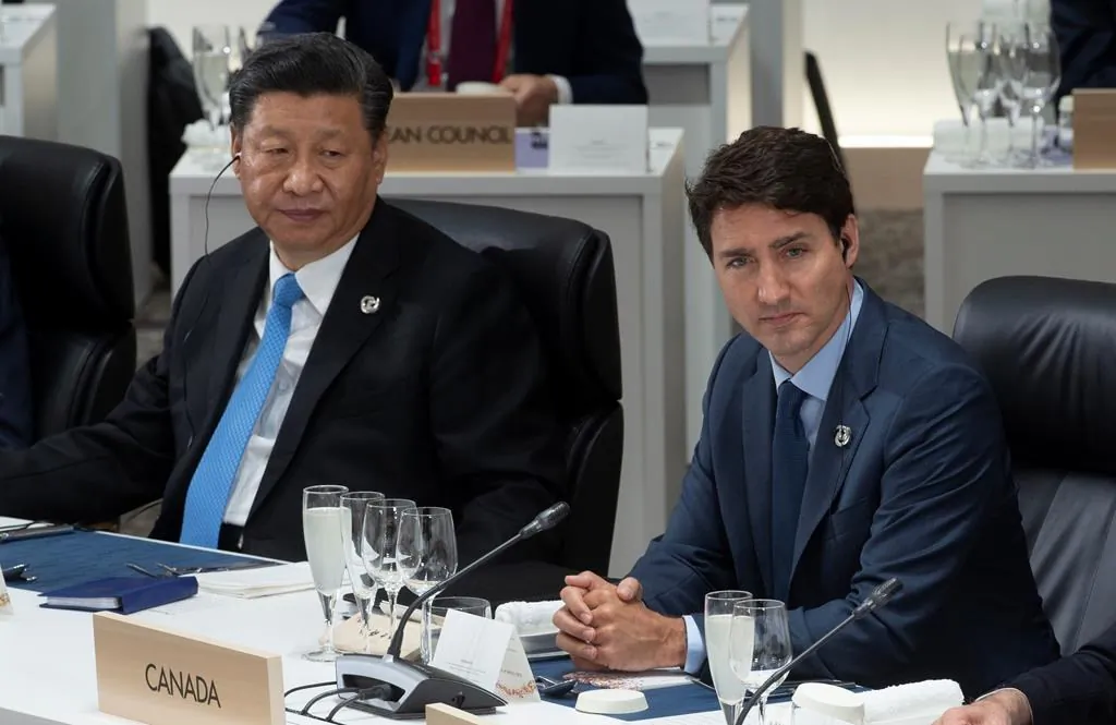 Canadian Prime Minister Justin Trudeau and Chinese President Xi Jinping listen to opening remarks at a plenary session at the G20 Summit in Osaka, Japan on June 28, 2019. (Adrian Wyld/The Canadian Press)