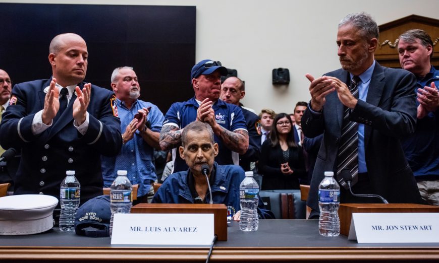 Retired Fire Department of New York Lieutenant and 9/11 responder Michael O'Connell, left, FealGood Foundation co-founder John Feal, center, and former Daily Show Host Jon Stewart, right, applaud following testimony from Retired New York Police Department detective and 9/11 responder Luis Alvarez during a House Judiciary Committee hearing on reauthorization of the September 11th Victim Compensation Fund on Capitol Hill in Washington on June 11, 2019. (Zach Gibson/Getty Images)
