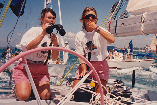 two women, binoculars, on boat