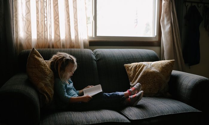 Stock image of a child on a couch. (StockSnap/Pixabay)