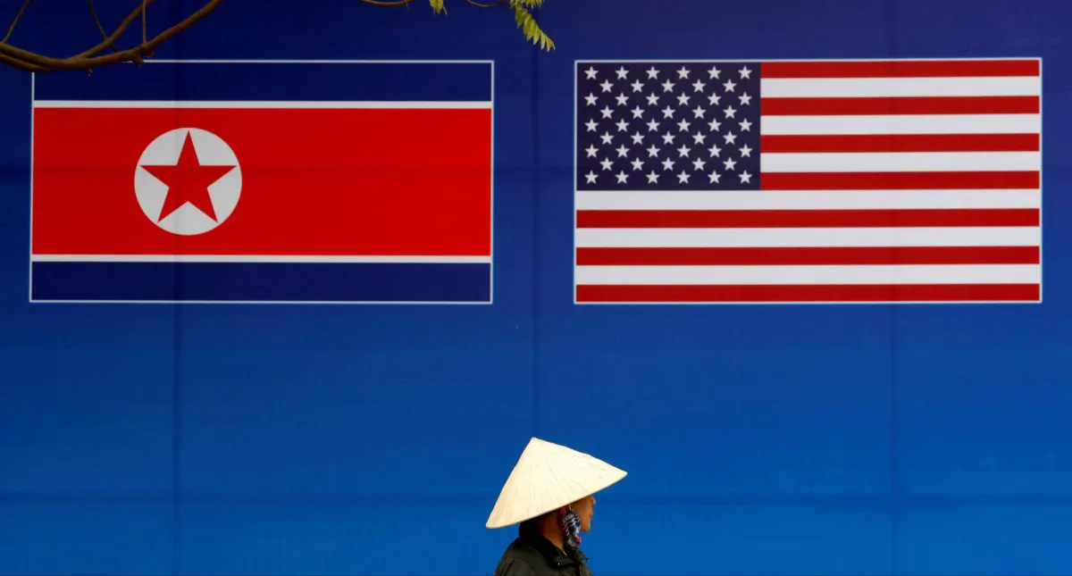 A person walks past a banner showing North Korean and U.S. flags ahead of the North Korea-U.S. summit in Hanoi, Vietnam, on Feb. 25, 2019. (Kim Kyung-Hoon/Reuters)